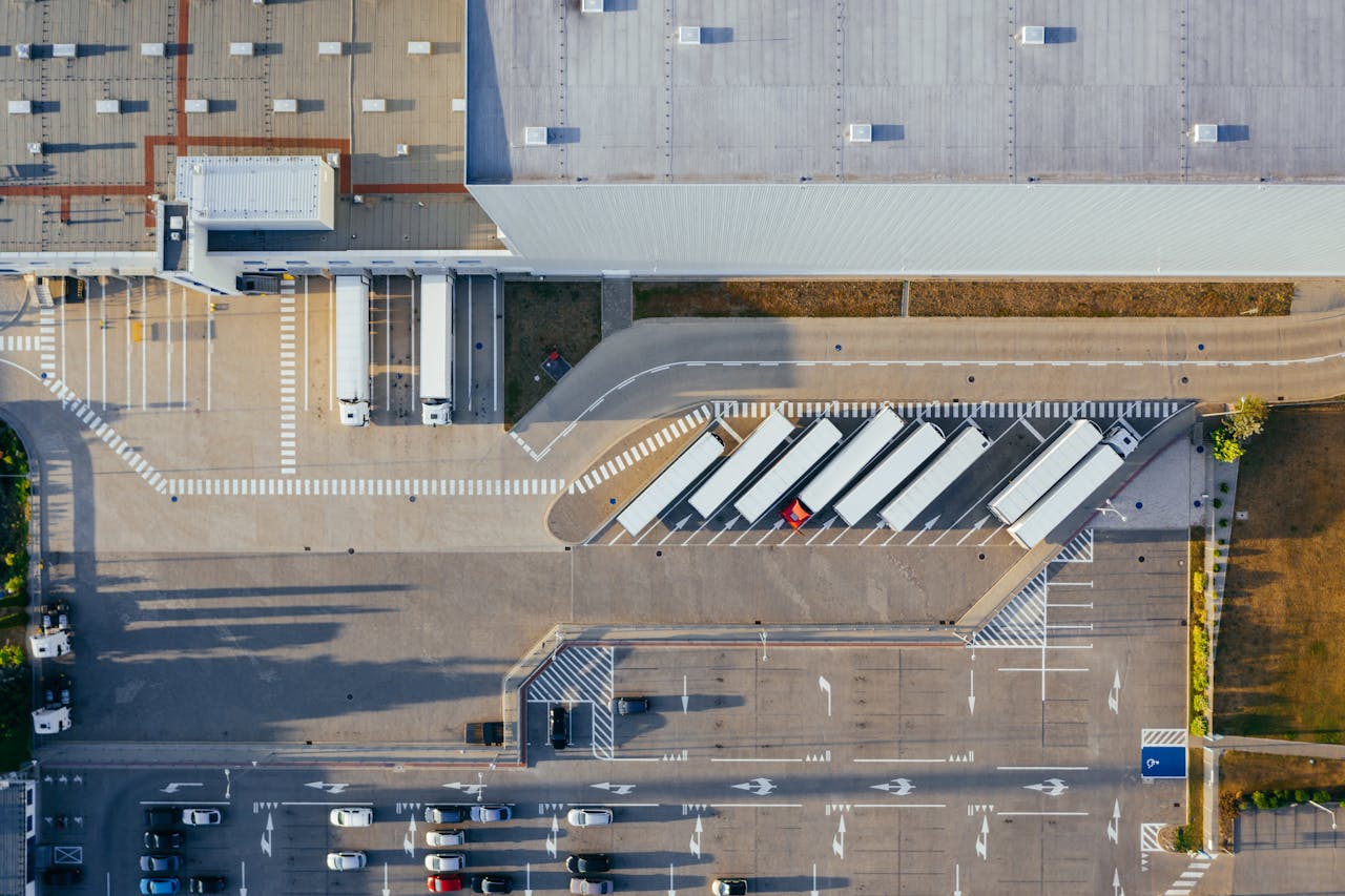 Home Drone shot of a logistics center with trucks and parking lot in Poznań, Poland.